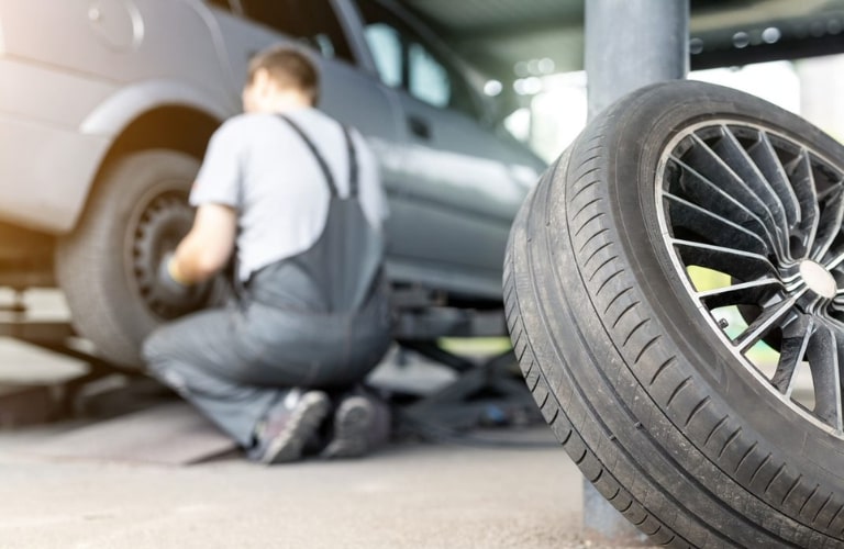 Service technician checking a vehicle's tire